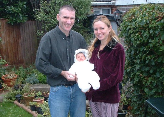 Katja with parents, 1 week old
